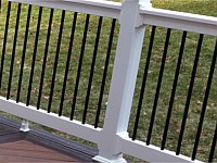 <b>Black aluminum balusters are a great addition to your new deck railing. They almost disappear when you are looking through to your view. Also shown here are feature boards in a different color on the deck. </b>