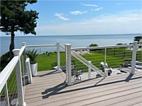 <b>TimberTech Azek Advanced PVC deck boards in the Vintage Collection in the color of Coastline.<br>Deck railing is white Ultralox aluminum railing with horizontal cable rail.
</b>