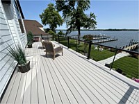 <b>TimberTech Azek Advanced PVC deck boards from the Vintage Collection in the color of Coastline with Ultralox black aluminum railing with horizontal cable rail look amazing with the unobstructed water view.</b>