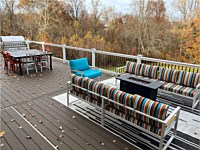 <b>TimberTech Composite Prime + Collection deck boards in the color Dark Cocoa with white vinyl railing with black aluminum balusters.</b>