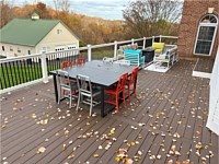 <b>TimberTech Composite Prime+ Collection deck boards in the color Dark Cocoa with white vinyl railing with black aluminum balusters.</b>