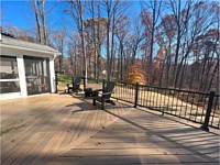 <b>TimberTech Composite Legacy Collection deck boards in the color of Tigerwood.  The Hand-scraped finish of the deck boards look fantastic in the diagonal layout. The railing is Ultalox Aluminum Railing with post caps lights.</b>