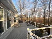 <b>TimberTech Composite deck boards in the Reserve Collection in the color of Driftwood in a herringbone pattern. Railing is white vinyl with black aluminum balusters.</b>