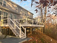 <b>TimberTech Composite deck boards in the Reserve Collection in the color of Driftwood. Railing is white vinyl with black aluminum balusters.</b>