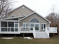 <b>Shed style screened porch with a screening system that includes Screeneze and Super Screen Mesh.  Composite deck boards and aluminum railing with glass panel infills complete the deck.</b>