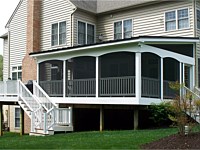 <b>Screened Porch with a shed style roof, complete with composite deck boards and white vinyl railing. An arched finish was given to the vinyl wrap on the exterior perimeter of the room. The screening system includes Screeneze and Super Screen Mesh.</b>