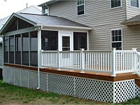 <b>Screened porch with gable style roof and the screening system includes Screeneze and Super Screen Mesh. Both deck and screened porch have composite deck boards and white vinyl railing with black aluminum balusters. The side of the deck is wrapped in matching fascia board, and the underside of the deck is wrapped in white vinyl lattice.</b>