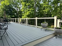 <b>Trex Composite deck boards in the color of Pebble Gray with tan vinyl railing and black round aluminum balusters in Annapolis, Maryland</b>