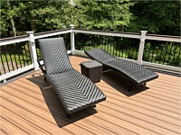 <b>Trex composite deck boards in the color of Tiki Torch with a Lava Rock feature board.  The railing is white PVC vinyl with a Lava Rock drink rail and black aluminum balusters.  Eyeball post lights on the railing to light up the space during the evening hours</b>