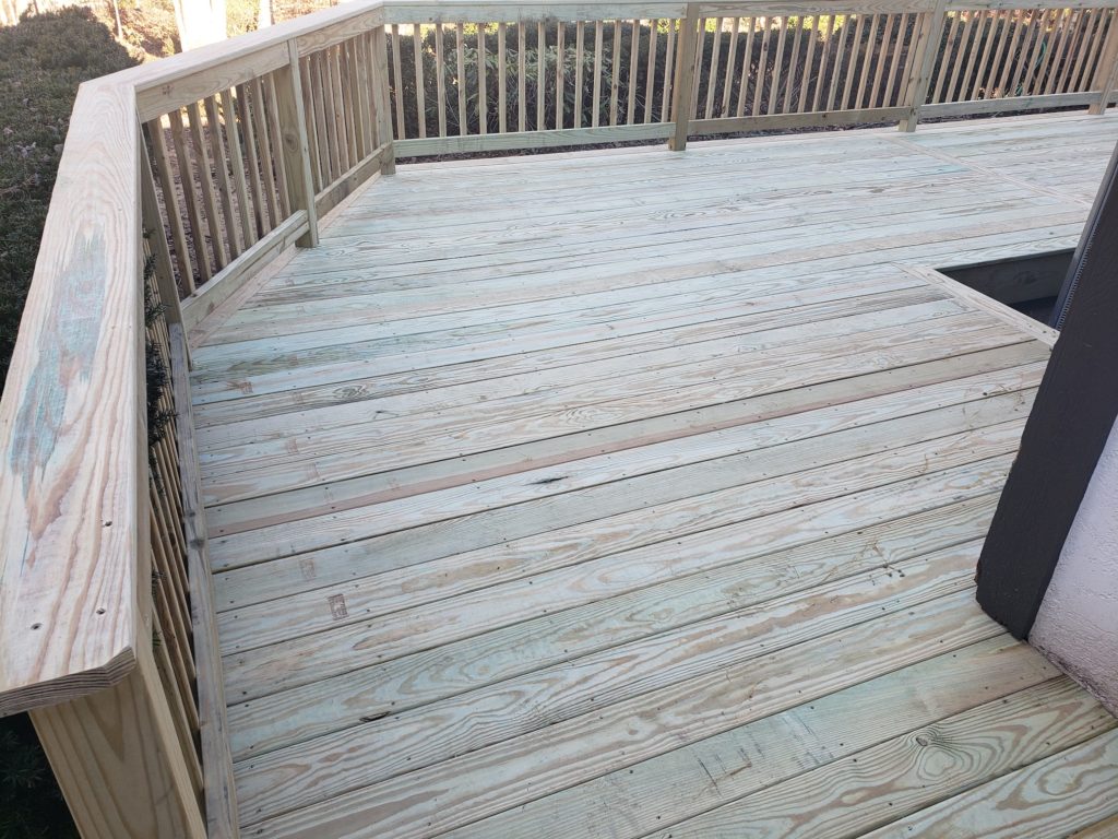 pressure treated wood deck with wood railing