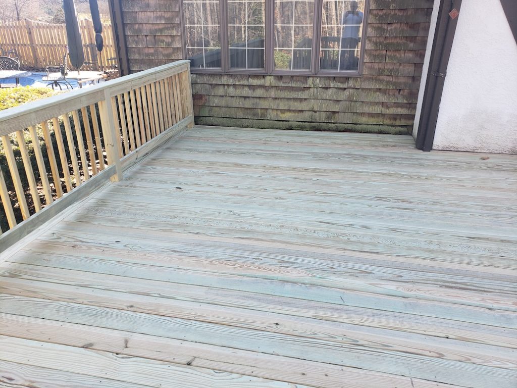 wooden deck with wood railings and balusters 