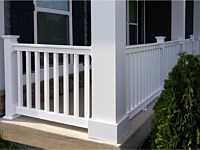 <b>White Square Vinyl Columns with white vinyl railing attached to a concrete porch floor</b>