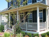 <b>White Round Columns with white vinyl railing and composite deck boards with white fascia wrap and white vinyl lattice wrap under the porch.</b>