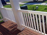 <b>View from the porch of square vinyl columns and white vinyl railing attached to brick porch flooring</b>
