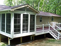 <b>Screened Porch with a gable style roof, complete with composite deck boards and white aluminum railing with black aluminum balusters. The porch is screened with Eze-Breeze sliding panel system that allows you to use your room all year round. The porch and deck are wrapped in low maintenance white fascia wrap.</b>