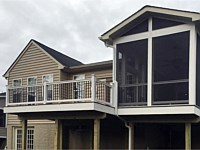 <b>Screened Porch with a gable style roof. The screening system includes Screeneze and Super Screen Mesh. Composite deck boards and white vinyl railing with black aluminum balusters outfit both the screened porch and deck. The entire structure is wrapped in white fascia wrap.</b>