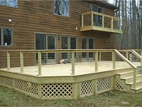 <b>Pressure treated wood deck and balcony with wood railing and cable rail.  The underside of the deck is wrapped in wood lattice</b>
