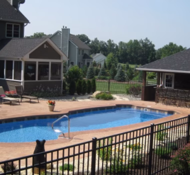 aluminum fence around a pool in the backyard