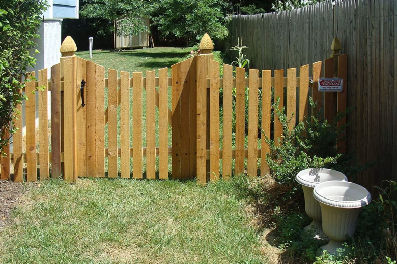 Concave Wood Picket Fence with French Gothic Fence Posts and Matching Gate