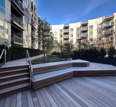 Wood Decking in Courtyard + Aluminum Pool Fencing + Aluminum Balcony Railing at Multifamily Complex