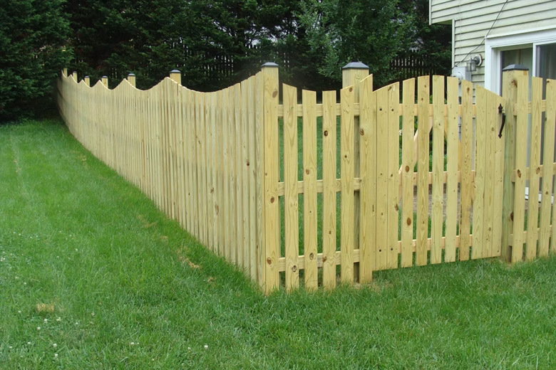 Spaced Picket Wood Fence with a Concave Dip and an Arched Gate