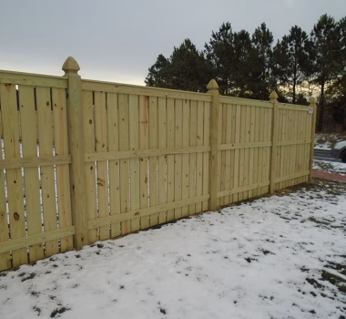 Vertical Board Spaced Picket Wood Fence with French Gothic Posts