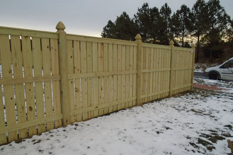 Vertical Board Spaced Picket Wood Fence with French Gothic Posts