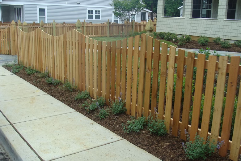 Wood Picket Fence with a Concave Dip and French Gothic Posts