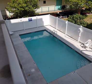 White Aluminum Railing and White Vinyl Pool Code Fencing at Hotel in OC MD