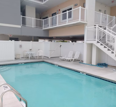 White Aluminum Railing and White Vinyl Pool Code Fencing at Hotel in OC MD