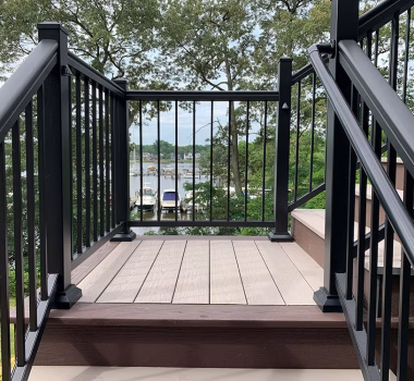 TimberTech Azek Harvest Slate Gray deck boards with Kona feature deck boards and stair risers + Black Ultralox Aluminum Railing