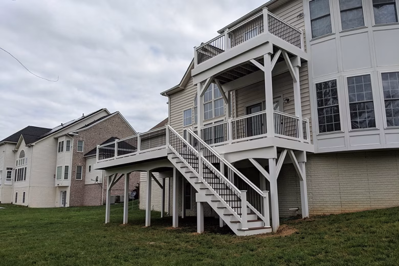 Trex Select Saddle Decking with White Washington Railing and Black Aluminum Balusters + Fascia and Support Posts and Beams are wrapped in White Vinyl in Bowie MD