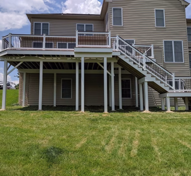 Trex Composite Decking with White Vinyl Railing with Black Aluminum Balusters White Vinyl Wrap around deck beams and support posts