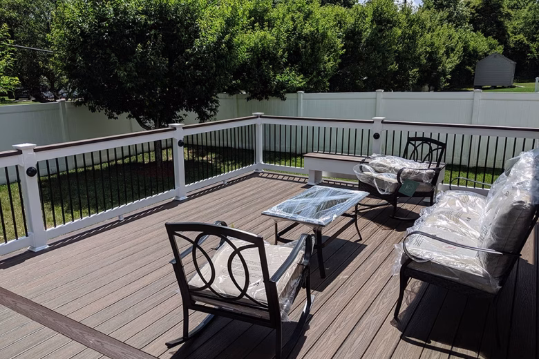 Trex Transcend Spiced Rum Deck Boards with White Lincoln Vinyl Railing Black Round Aluminum Balusters and matching cocktail rail + black eyeball lights in Ellicott City MD