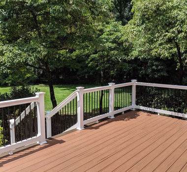 Trex Transcend Tiki Torch Deck Boards with White Washington Vinyl Railing and Black Aluminum Balusters