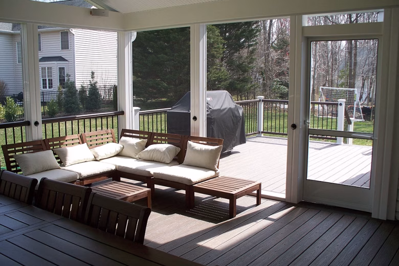 View from inside a screened porch looking out over the deck
