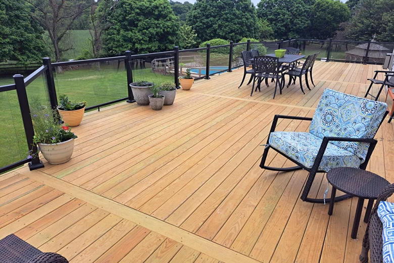 Pressure Treated wood deck with aluminum railing with glass inserts