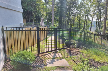 black aluminum fence and gate with wood
