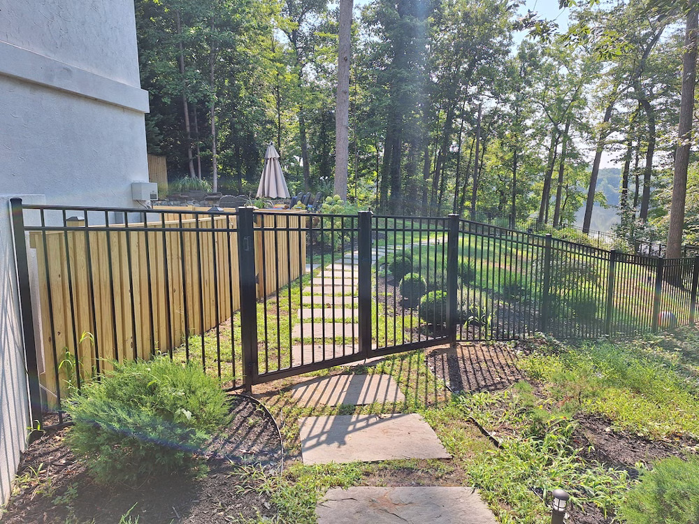 black aluminum fence and gate with wood