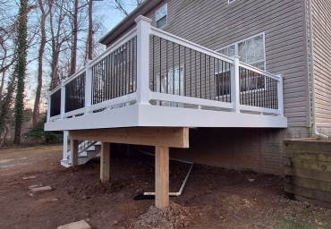 pressure-treated wood frame and 256 sq. ft. of Trex Enhance decking in the Tide Pool hue with detail of white railing