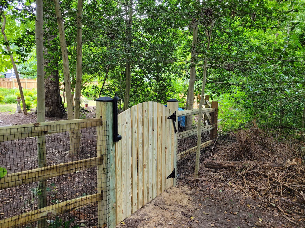 pressure treated 3-rail split rail fencing with black vinyl coated mesh