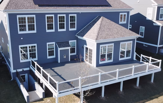 composite deck on the back of a beautiful blue vinyl siding