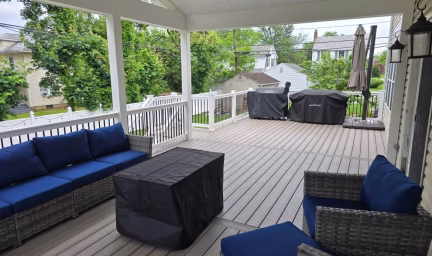 Trex deck and porch decorated with blue wicker furniture