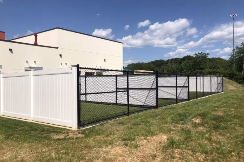 Chain Link Interior Fence with White Slats and White Vinyl Privacy Exterior Fence at Dog Kennel